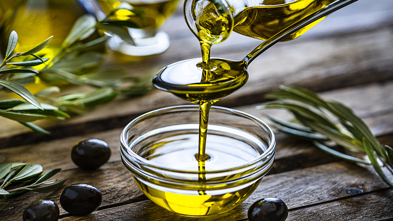 olive oil pouring on spoon