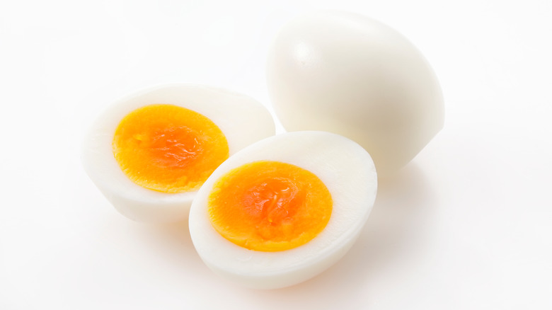 Soft-boiled eggs on white background