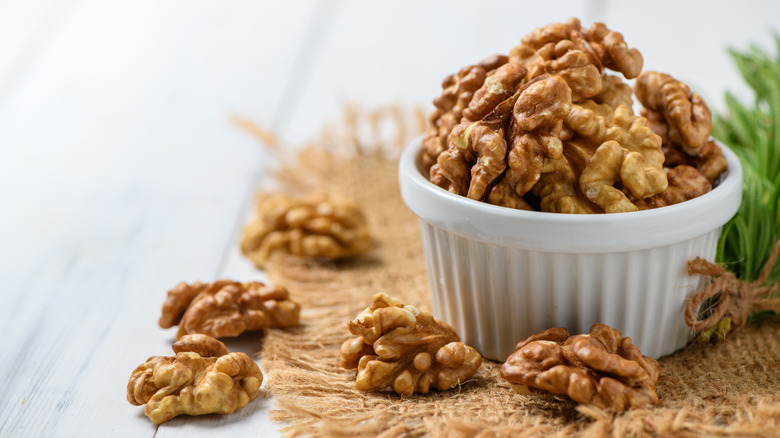 Walnuts in cup on table