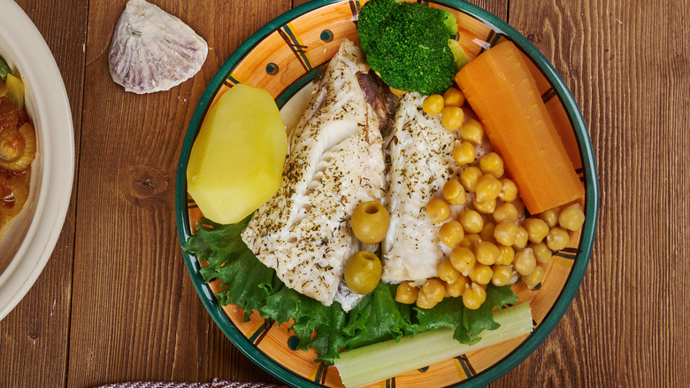 Cod surrounded by vegetables and chickpeas