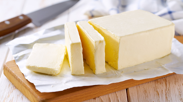 Butter cut into slices on cutting board