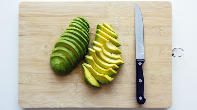 Sliced avocado on cutting board