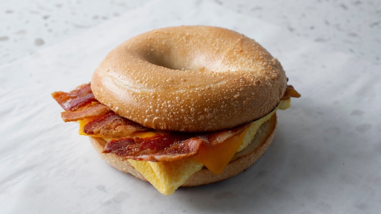 Eggs and bacon bagel sandwich