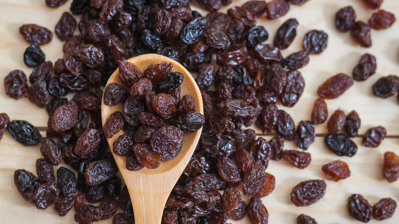 Spoonful of raisins on countertop 