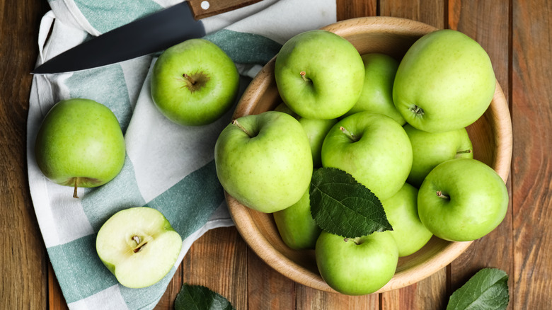 Green apples on table