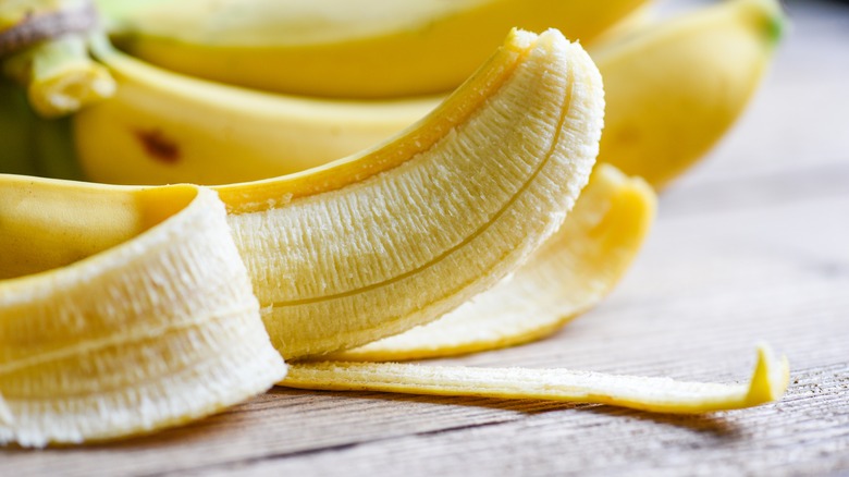 Peeled banana on table