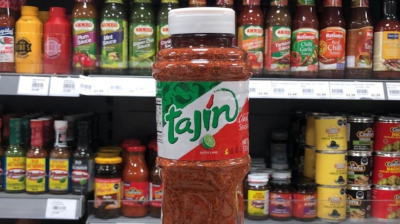 Hand holding bottle of Tajin