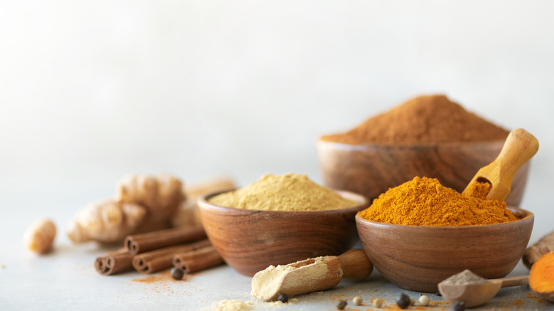 Wooden bowls with mixed spices