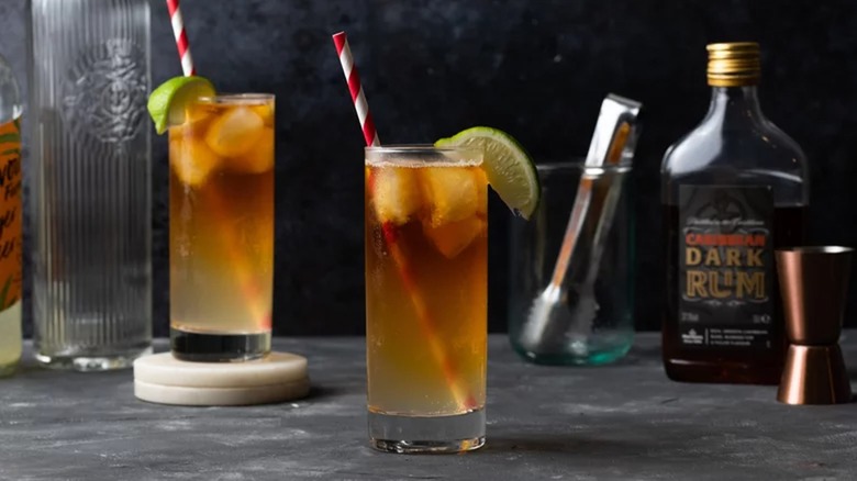 Dark and Stormy cocktails in tall glasses with dark rum and jigger