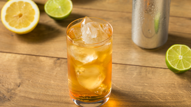 Foghorn cocktail in glass with lemons and limes