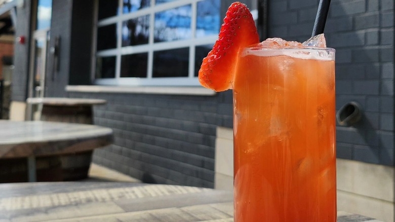 Kentucky buck cocktail on table outside grey building