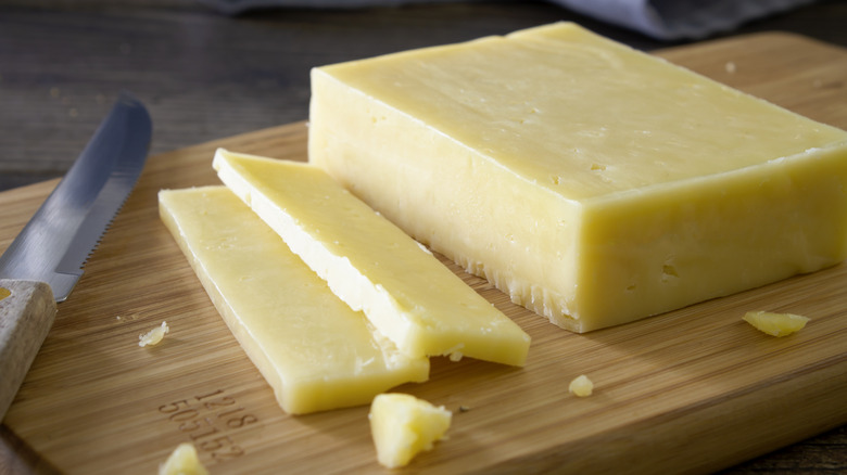 sliced cheddar on wooden board