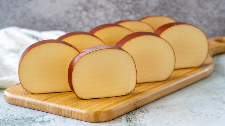 slices of smoked gouda on wooden board