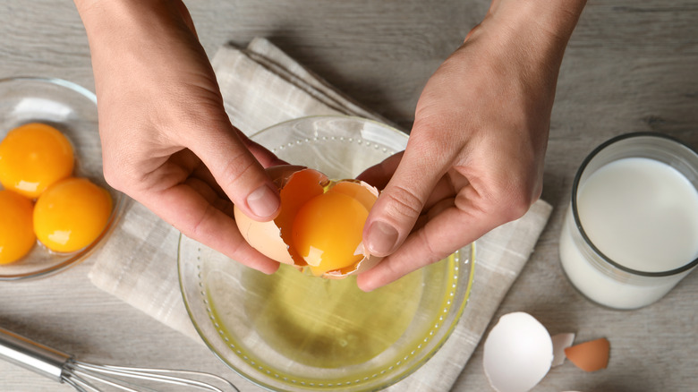 Eggs cracking in bowl 