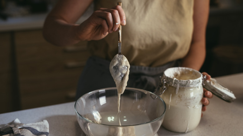 Spooning starter from glass jar