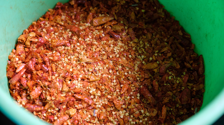 Bucket of dried chiles ground into pieces