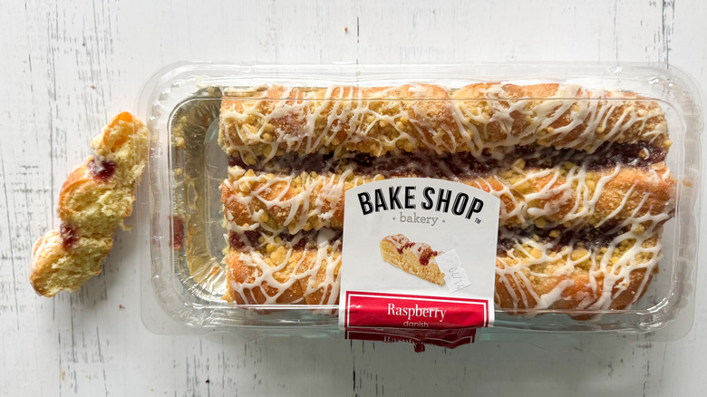 Raspberry Danish and container on a white board