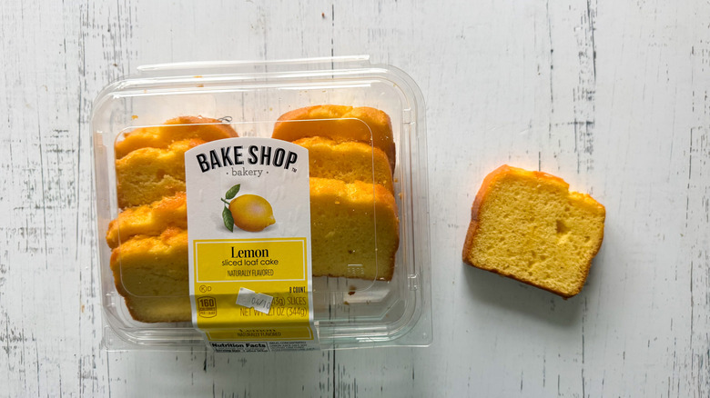 Lemon cake loaf slices and container on a white board