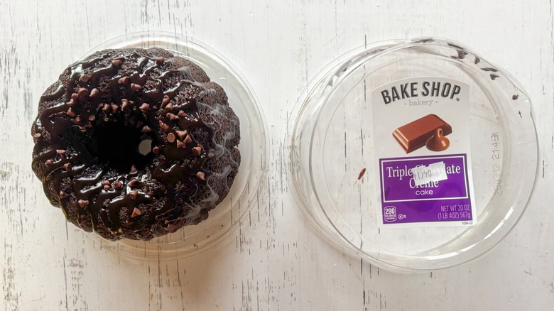 Tripe chocolate creme cake and container on a white board