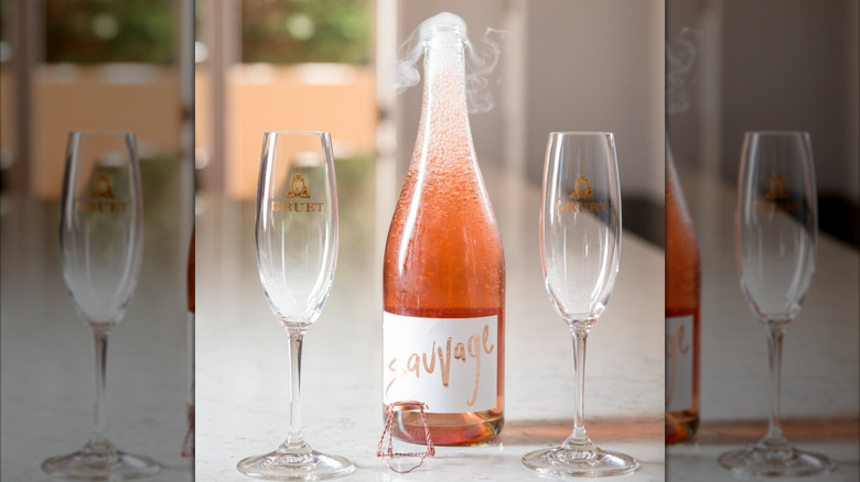 bottle of rosé sparkling wine with two glasses