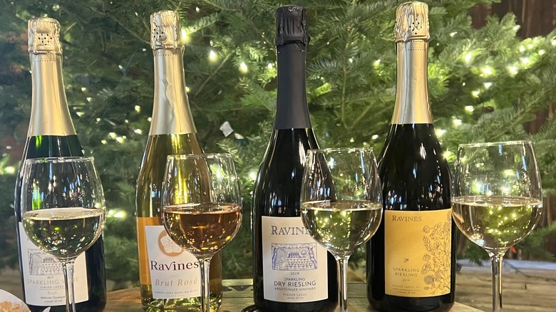 lineup of sparkling wine bottles and glasses