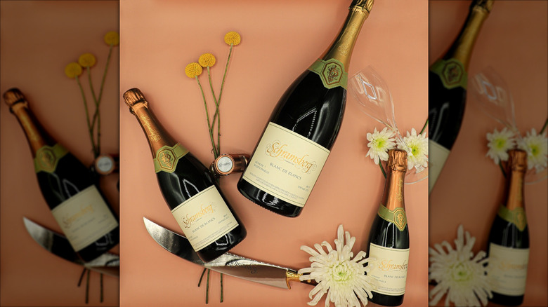 three bottles of sparkling wine with flowers