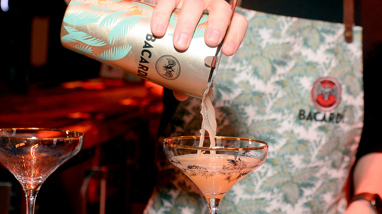 cocktail being poured into glass