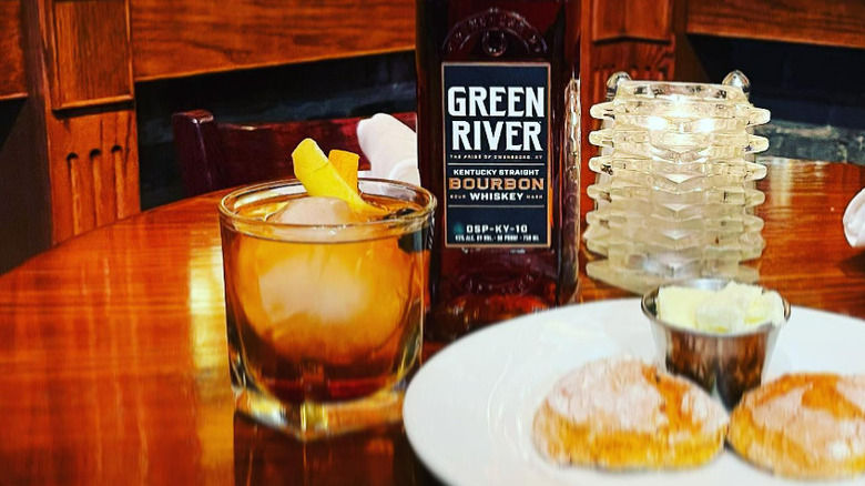 bottle of bourbon and glass on table