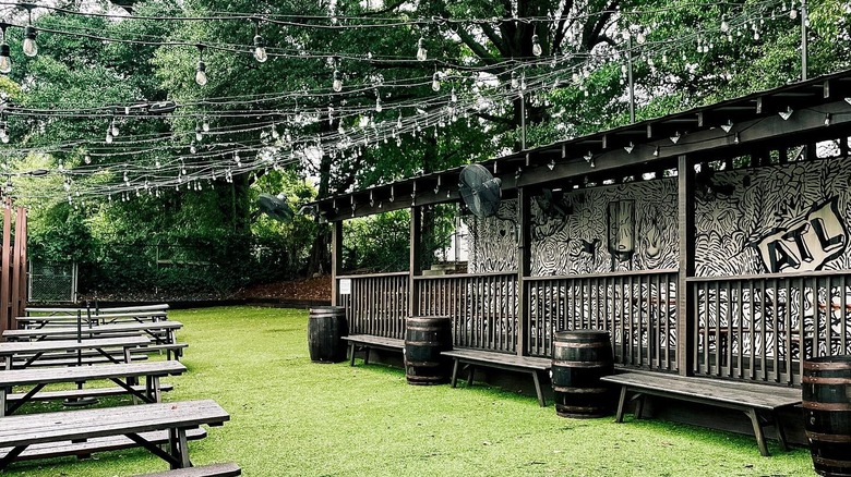 Outdoor beer garden lined with picnic tables