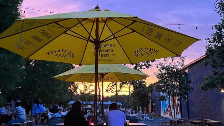 People sitting under yellow umbrella