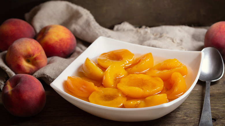 Canned peaches on white plate