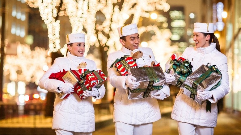 Hotel staff surrounded by holiday lights