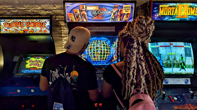 Couple playing arcade game