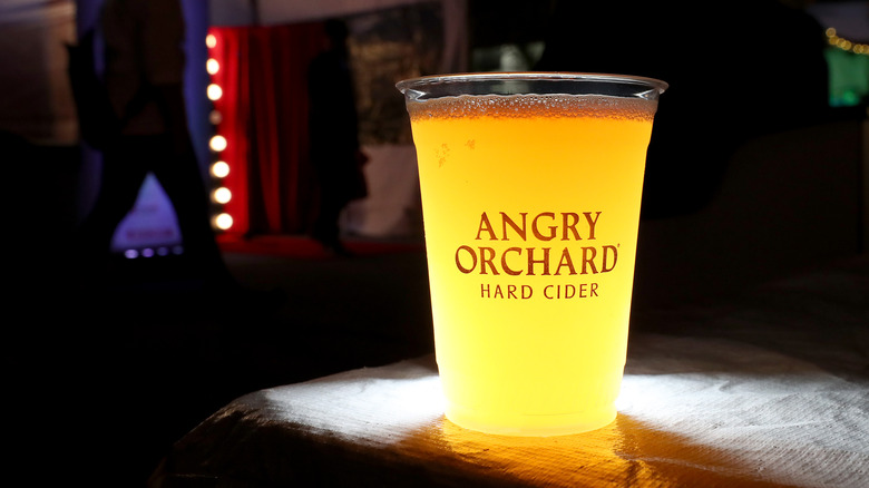 Angry Orchard cider in branded cup on bar