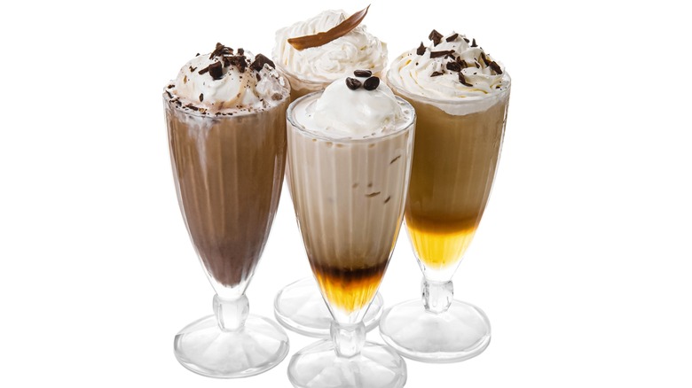 Various layered milkshakes in tall glasses