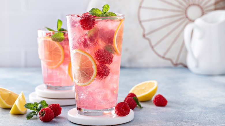 Raspberry lemonade with berries and lemons