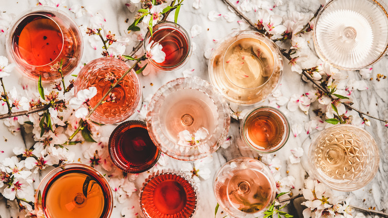 Rosé wine in various glasses with apple blossoms