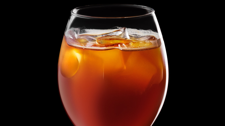 Orange beverage in wine glass