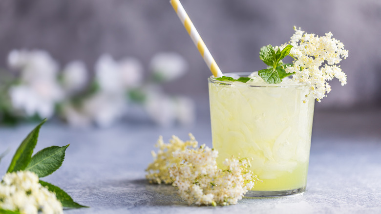 Glass with straw and flowers