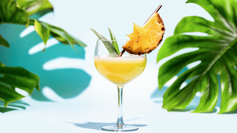 Glass with pineapple and leaves