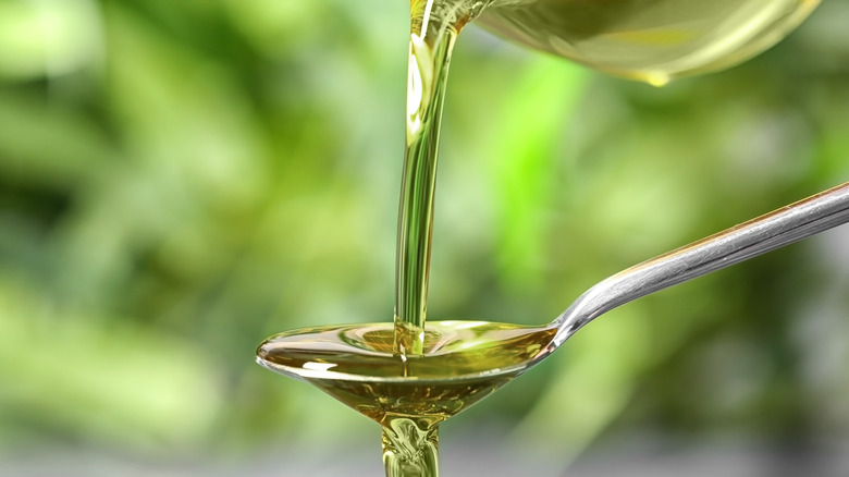 Hemp oil poured in spoon