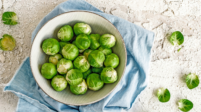 Fresh Brussels sprouts in white bowl