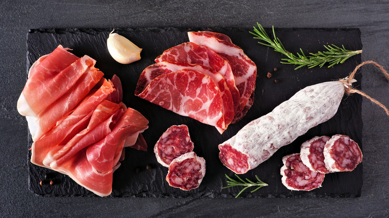 Variety of cured meats on cutting board