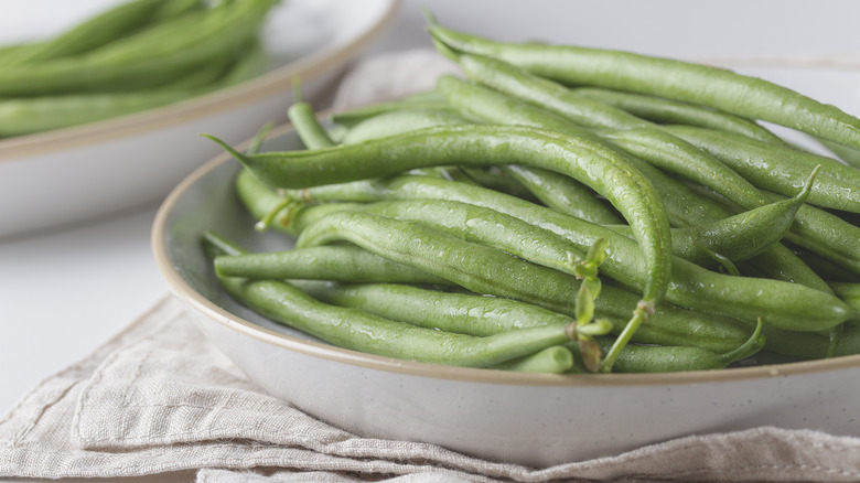 Fresh green beans on white plate