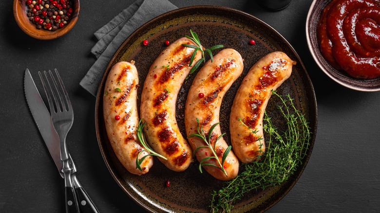 Grilled sausage on black plate