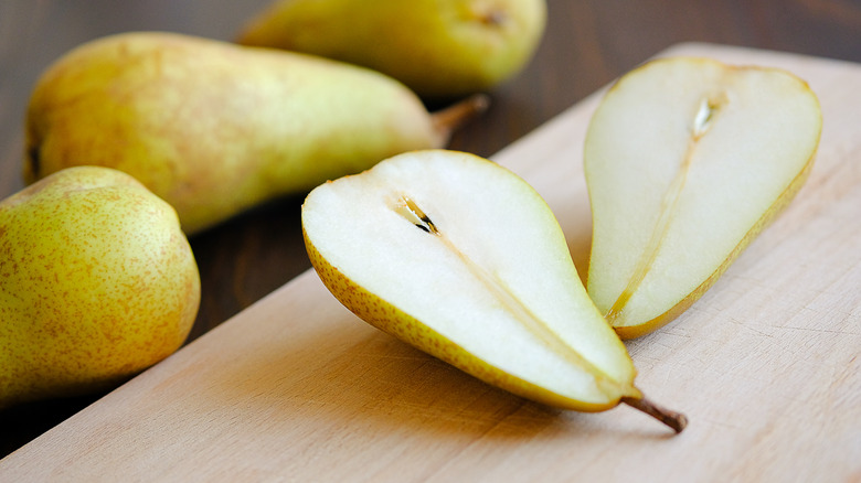 Halved pear on cutting board