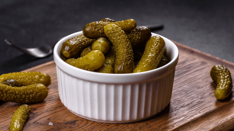 Cornichons in white bowl on table