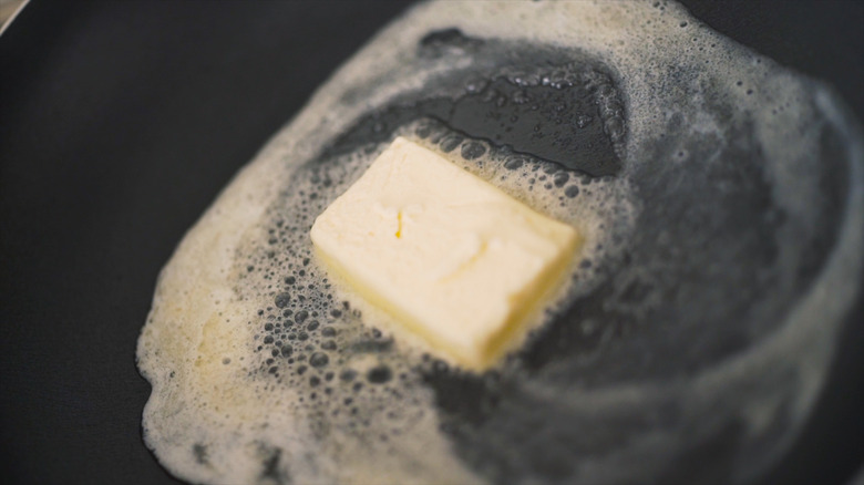 butter melting in black pan