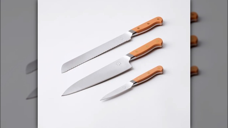 five two knife surrounded with herbs