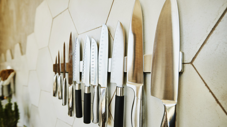 Kitchen knives set handing on kitchen wall